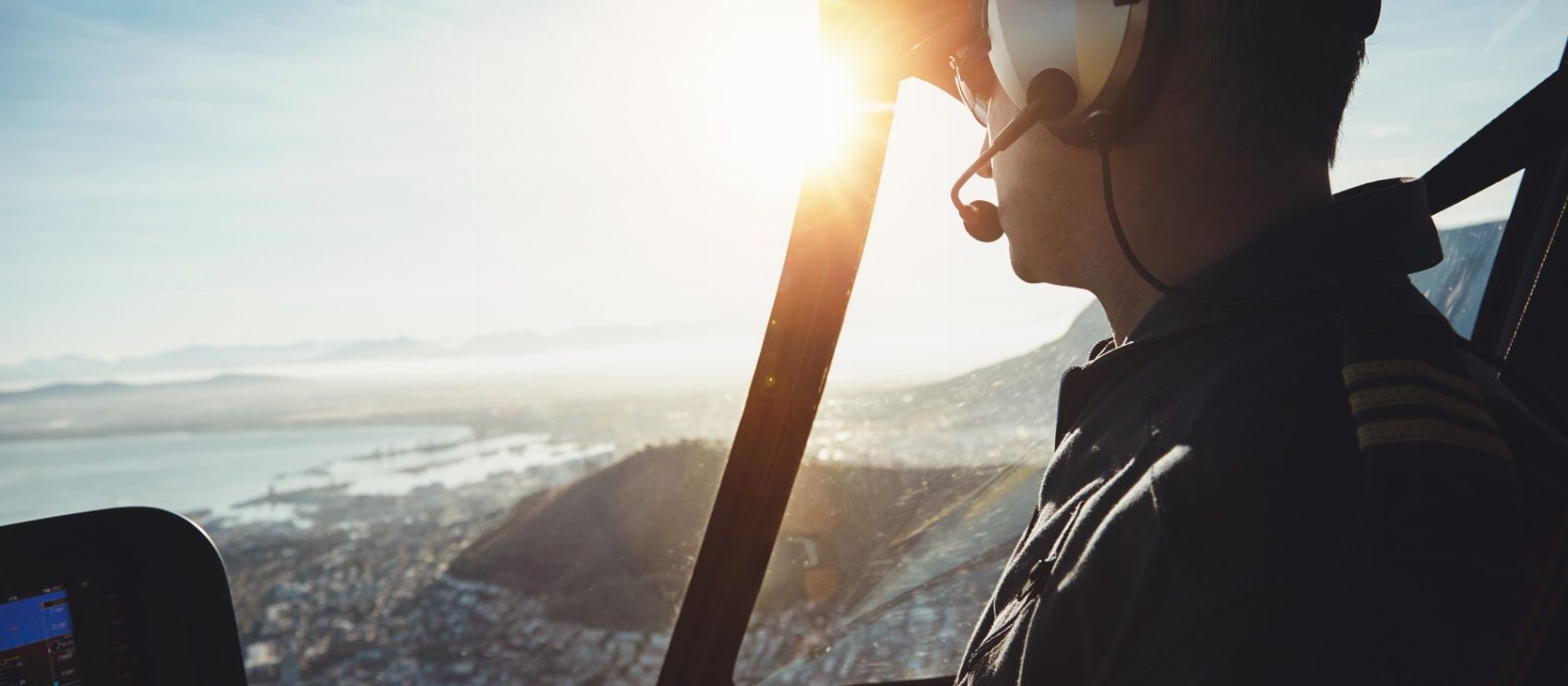 Helicopter pilot in the cockpit over a city