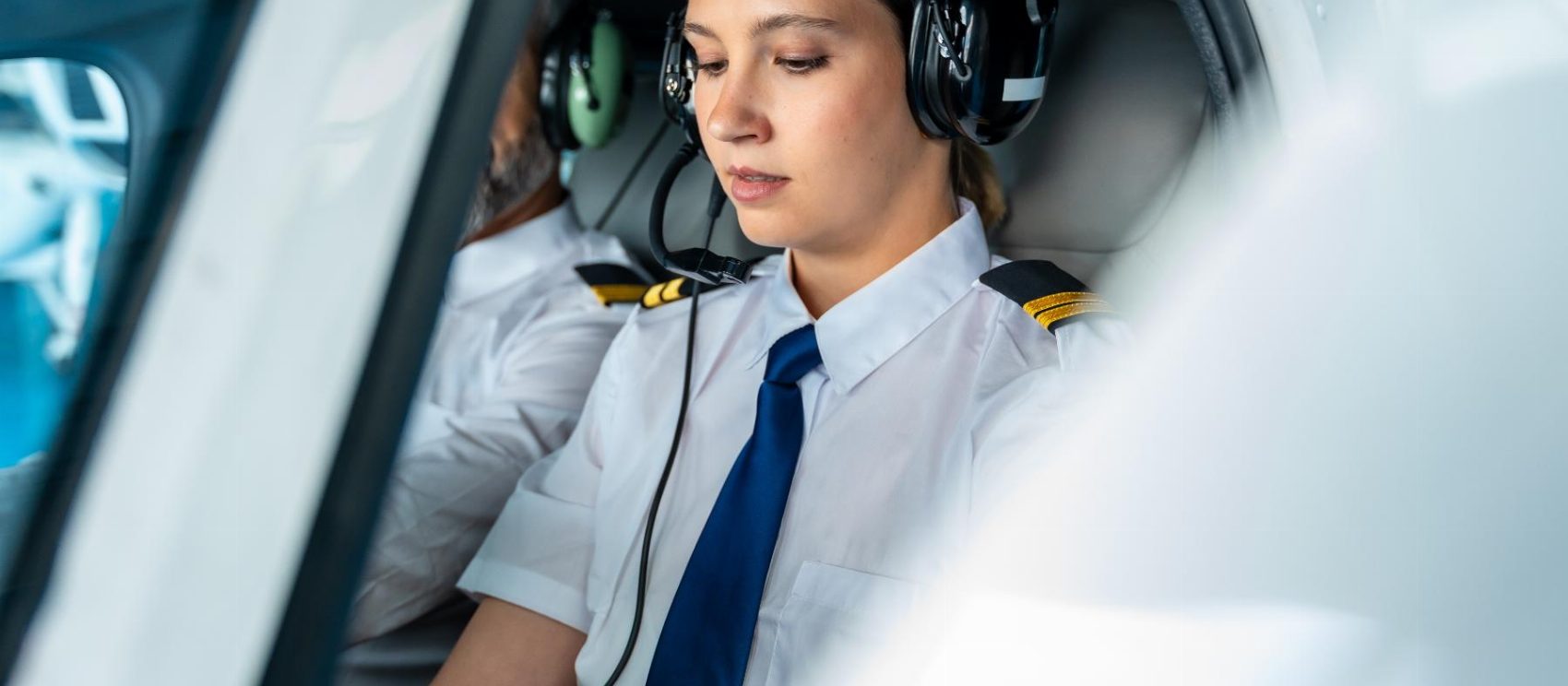 Student pilot wearing a headset at the controls during flight training